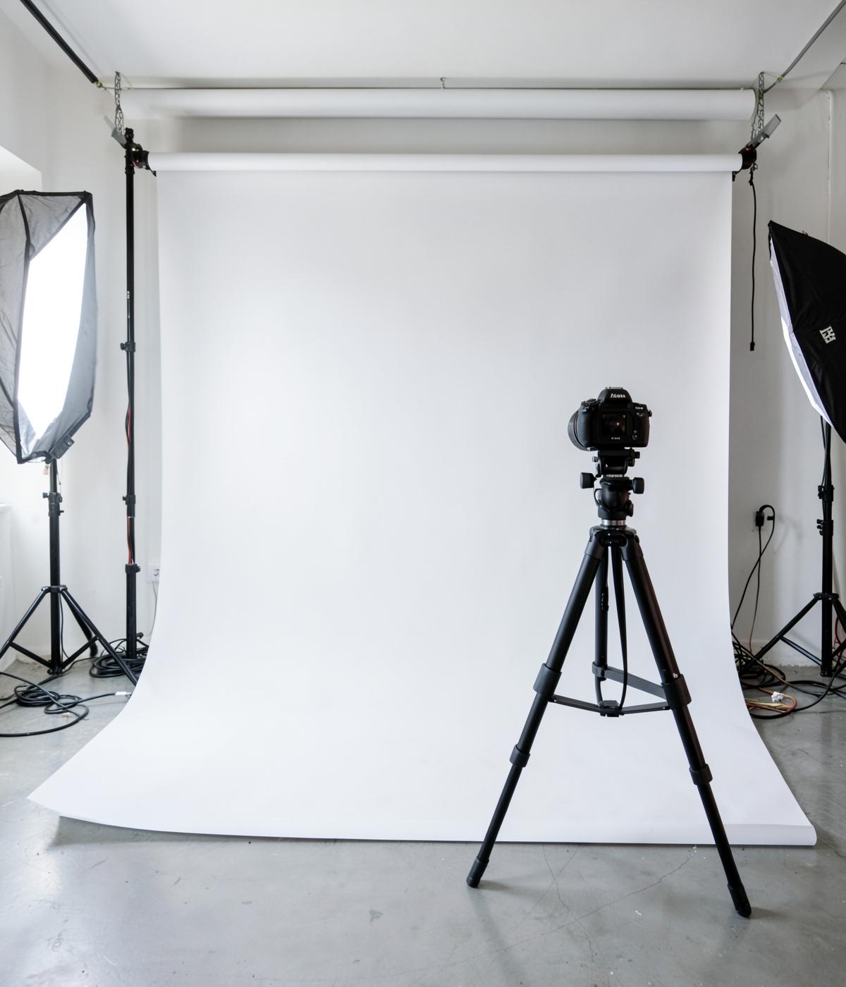 Photography studio with camera, lighting and seamless backdrop